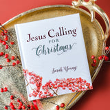 Book titled 'Jesus Calling for Christmas' by Sarah Young on a decorative tray with berries and antlers.
