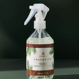 Frasier Fir deodorizing spray bottle on a dark background