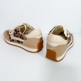 Pair of beige sneakers with leopard print accents on a white background