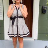 Woman in a striped dress standing on a porch