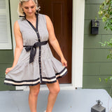 Woman in a striped dress standing on a porch