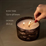 Candle being lit with a match, Thymes logo visible, on a dark background
