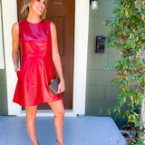 Woman in a red dress standing on a porch