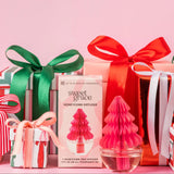 Sweet Grace honeycomb tree diffuser with wrapped gifts on a pink background