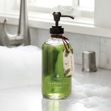Green bottle of Thymes Frasier Fir hand wash on a bathroom counter