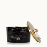 Black marble candle holder with gold lid featuring Thymes logo on a white background