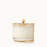 Decorative candle holder with gold accents on a white background