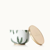 Ceramic jar with green leaf pattern and gold lid on a white background