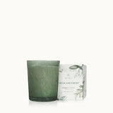 Green candle with packaging labeled 'Highland Frost' on a white background