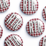 Several round pin-back buttons with a red and white gingham pattern and the letters 'RTR' in bold white with black outlines, arranged on a white background.