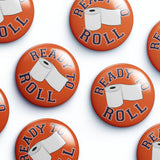 Collection of 'Ready to Roll' buttons with toilet paper graphics on an orange background.