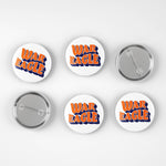 Six round pin-back buttons on a light gray background, showing both the front and back views. The front buttons feature the words 'WAR EAGLE' in orange with a blue outline, while the back buttons show the silver metal pin mechanism.