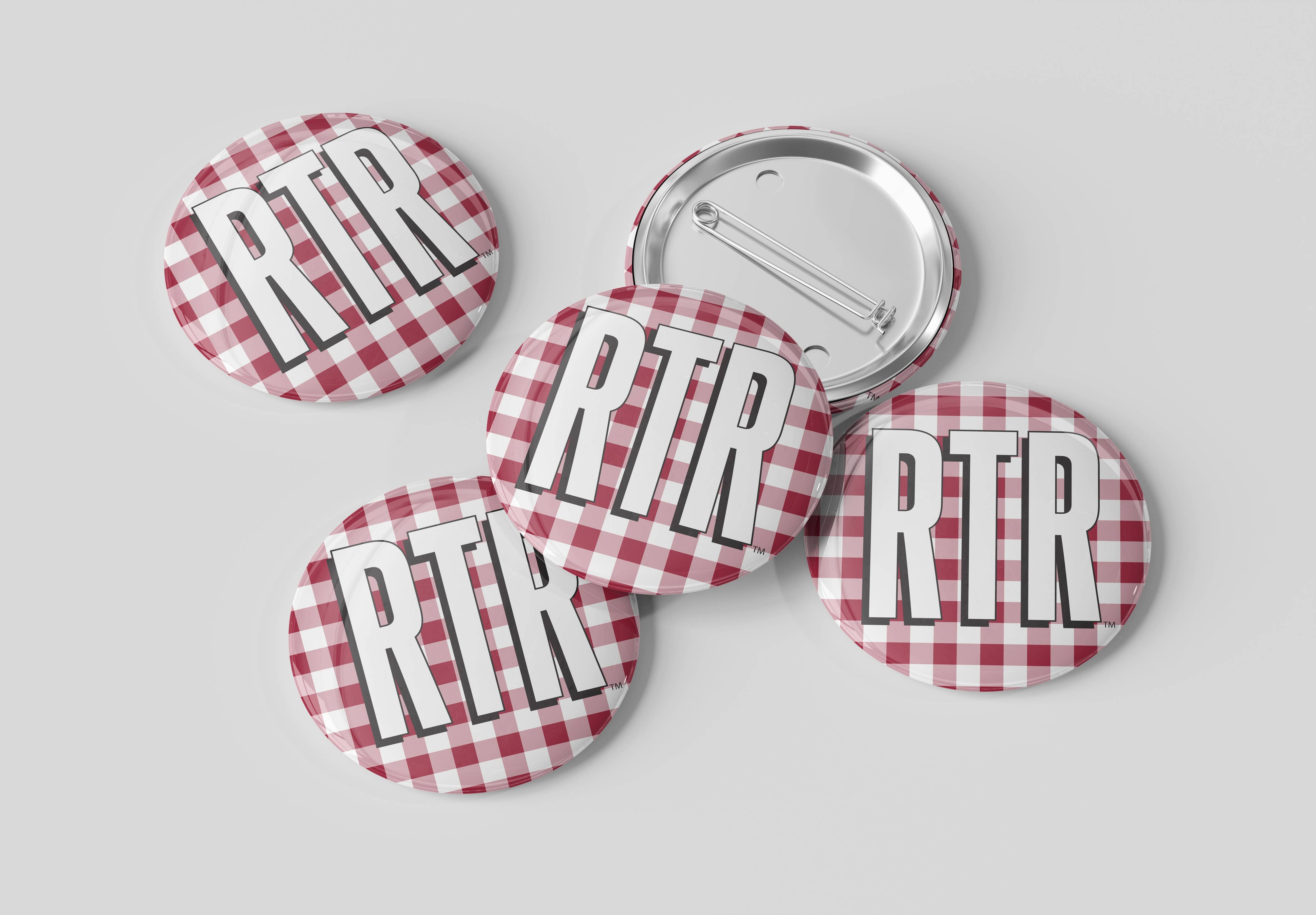 Five round pinback buttons with a red and white gingham pattern and the text 'RTR' in bold white letters outlined in black, shown on a light gray background. One button is turned over to show the metal pin back.