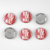 Six round pin-back buttons arranged in two rows on a light gray background. Four buttons show the front design with red and white vertical stripes and the words 'ROLL TIDE ROLL' in white text, and two buttons show the silver metal back with pin fastening.
