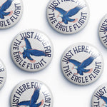 Collection of buttons with an eagle design and text on a white background
