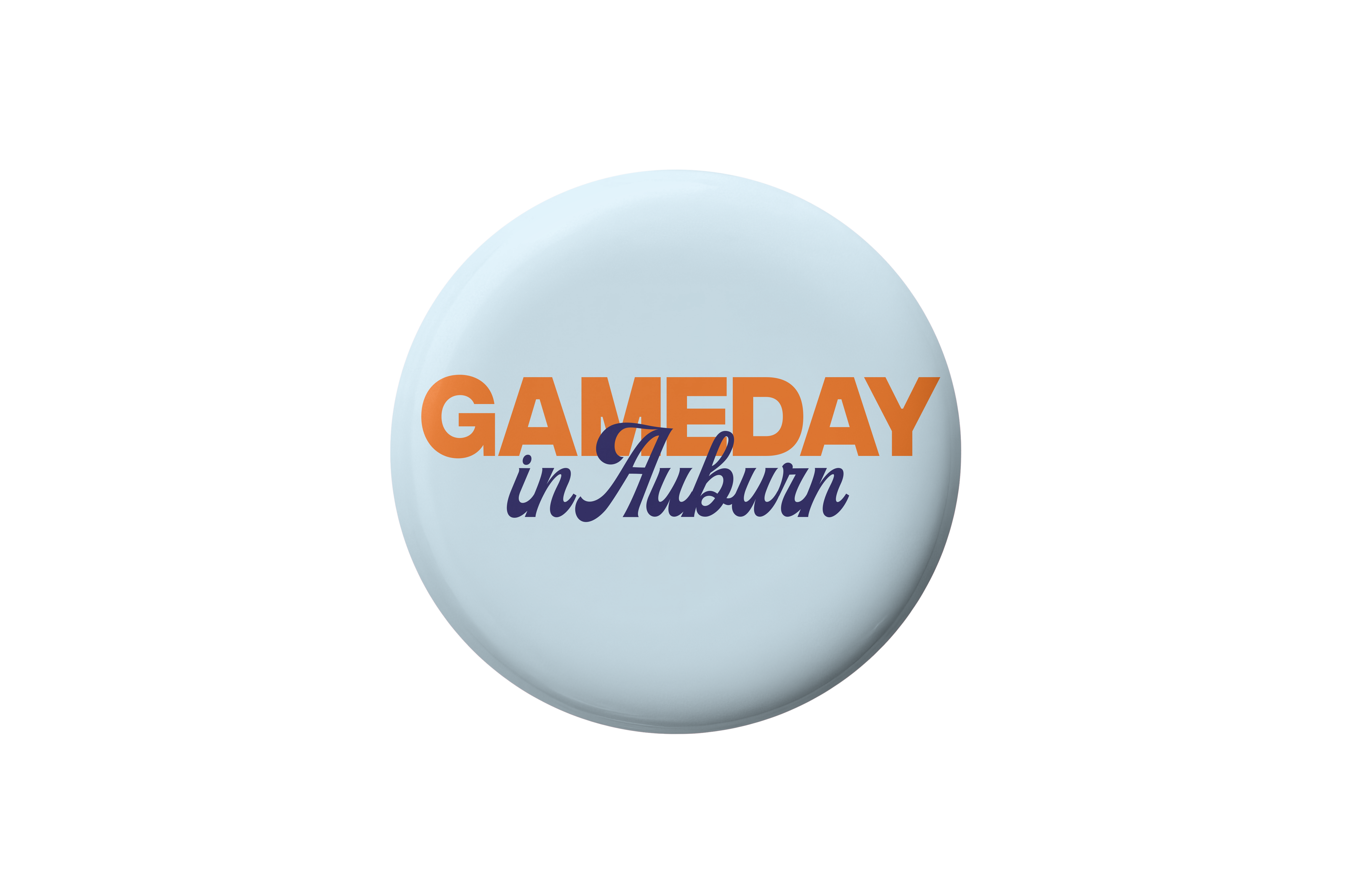 A round light blue button badge featuring the text 'GAMEDAY in Auburn' in orange and navy blue lettering, centered on a plain white background.