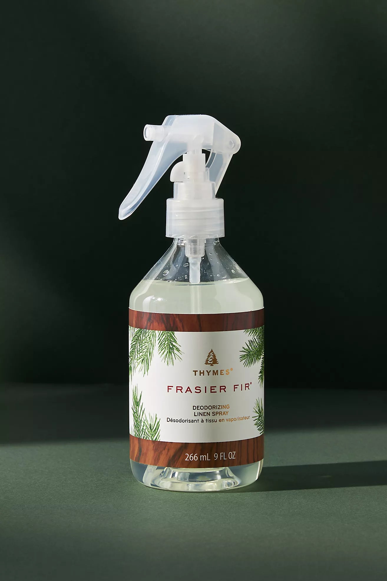 Frasier Fir deodorizing spray bottle on a dark background