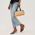 Person holding a beige clutch bag with a plain background