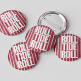 Five round pin-back buttons with a red and white striped pattern and the text 'ROLL TIDE ROLL' in white, with one button showing the silver metal back, on a light gray background.