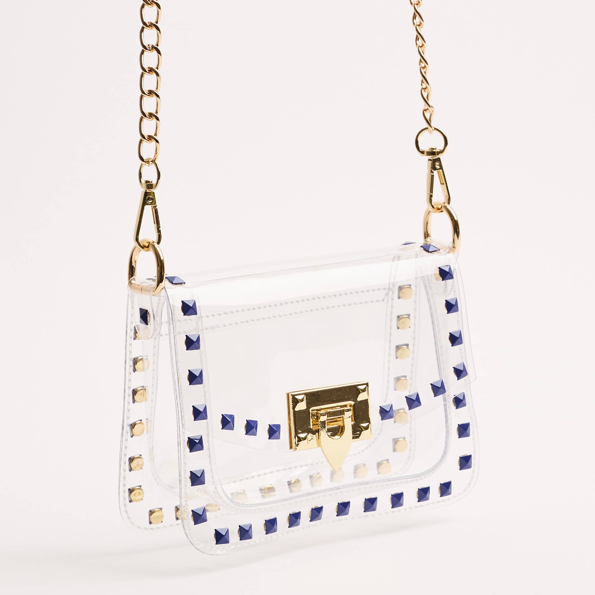 White handbag with gold accents and blue stud details on a white background