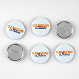 Six round pin-back buttons shown on a light gray background, including three front views and three back views. The front buttons have a white background with orange and blue text reading 'GAMEDAY in Auburn'.