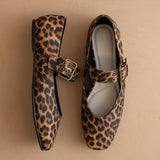 Leopard print shoes with buckles on a beige background