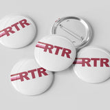 Five round pin-back buttons with a glossy white surface, featuring the red letters 'RTR' with two thin red stripes, shown on a light gray background. One button is turned over to show the silver metal pin-back mechanism.