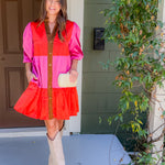 Woman in a colorful dress standing on a porch