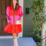 Woman in a colorful dress standing on a porch