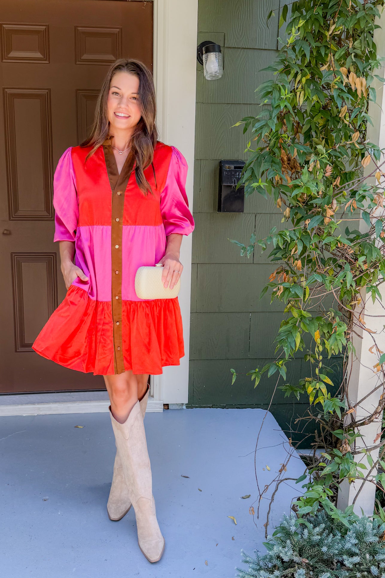 Woman in a colorful dress standing on a porch