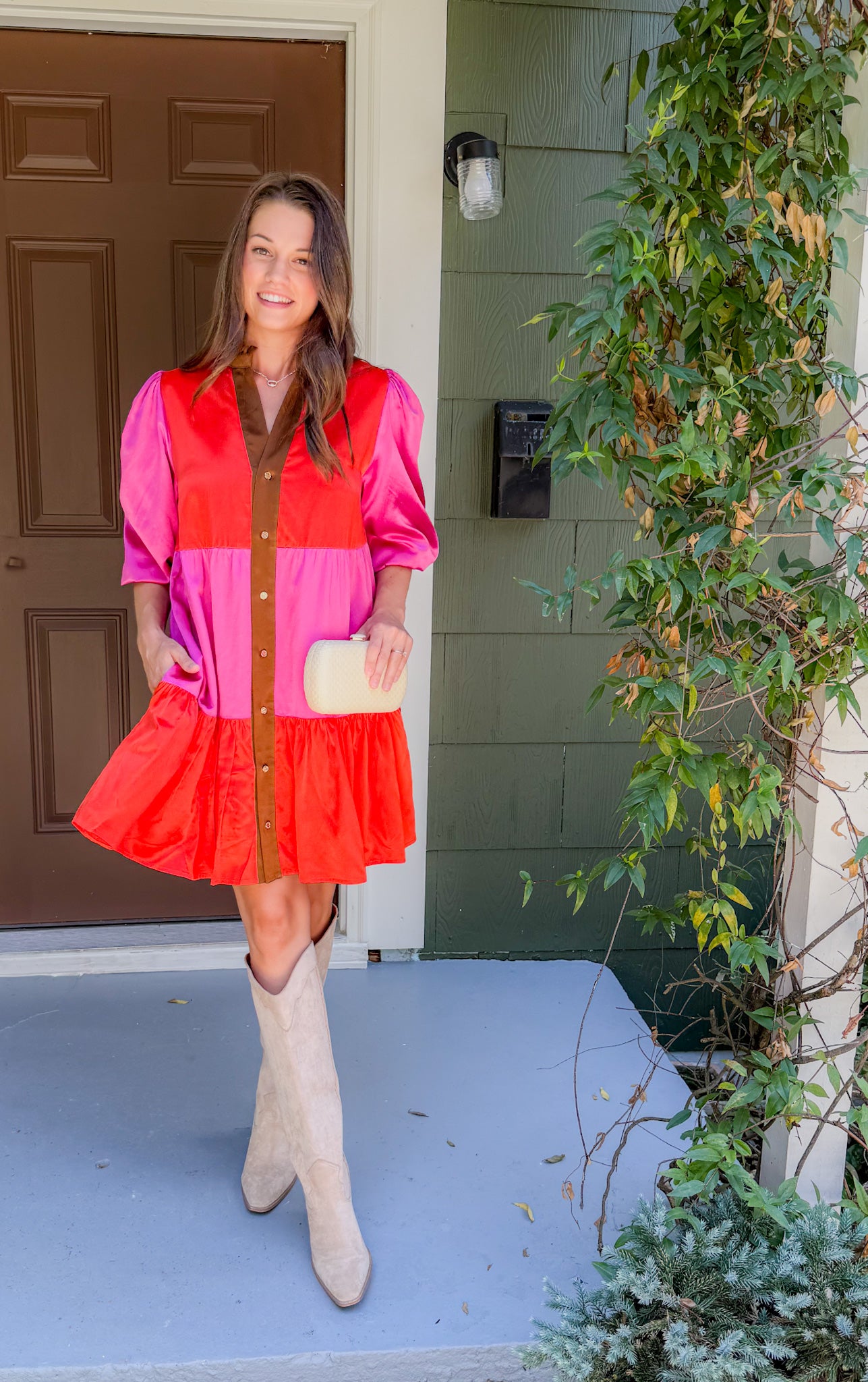 Woman in a colorful dress standing on a porch