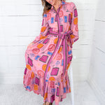 Woman wearing a colorful patterned dress with a white background