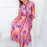 Woman wearing a colorful patterned dress with a white background