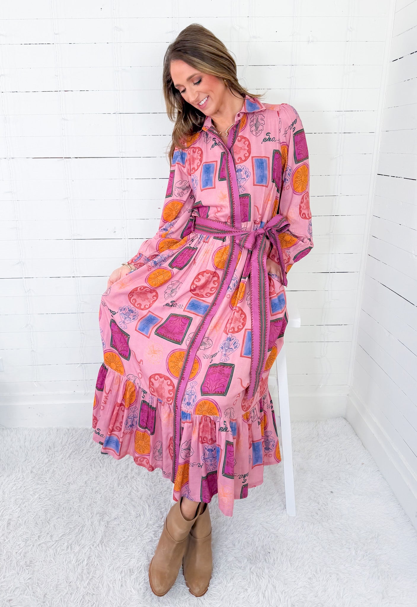Woman wearing a colorful patterned dress with a white background