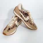 Pair of tan sneakers with leopard print pattern on a white background