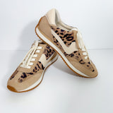 Pair of tan sneakers with leopard print pattern on a white background