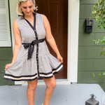 Woman in a striped dress standing on a porch