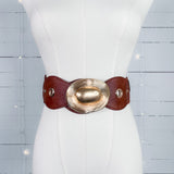 Mannequin wearing a wide leather belt with a gold buckle on a light blue background
