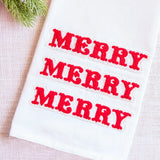 White towel with red 'MERRY' text on a light background