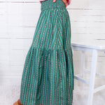 Person wearing green patterned pants with a white background