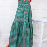 Person wearing green patterned pants with a white background