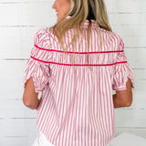 Woman wearing a red and white striped shirt with a white background