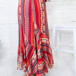 Colorful patterned dress with a white chair in the background