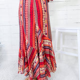 Colorful patterned dress with a white chair in the background