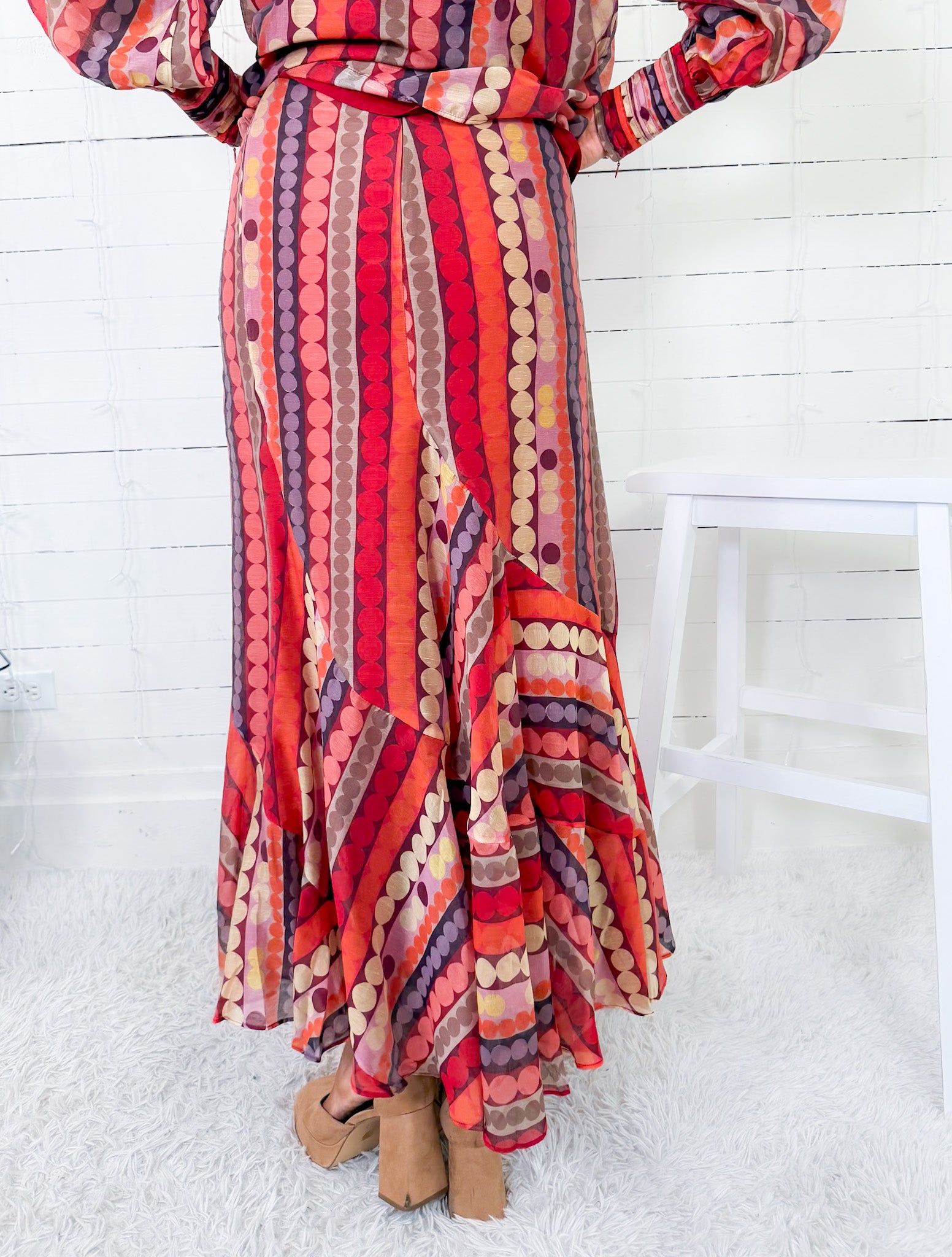 Colorful patterned dress with a white chair in the background