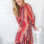 Woman wearing a colorful patterned dress against a white background