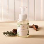 Frasier Fir foaming hand wash bottle with natural elements on a beige surface
