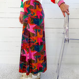 Person wearing a colorful patterned skirt with a white background