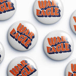 Several round white button badges with the words "WAR EAGLE" in orange and navy blue are arranged on a light gray background.