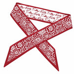 Red bandana with white floral patterns and text on a white background